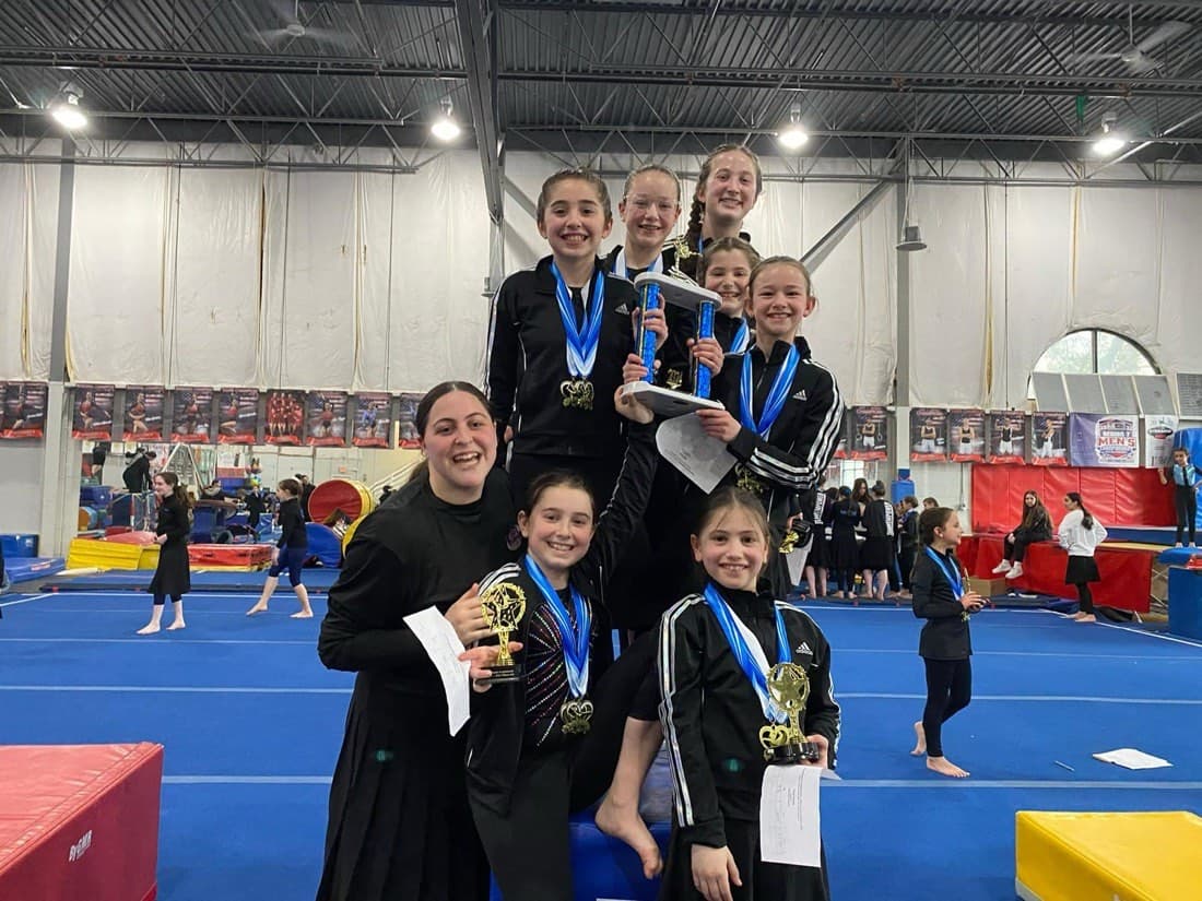 A JGL team with medals and trophies
